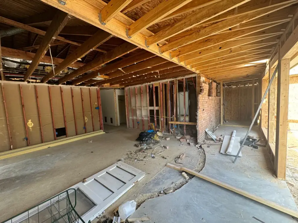 House interior opened to the studs and ceiling joists during structural repair