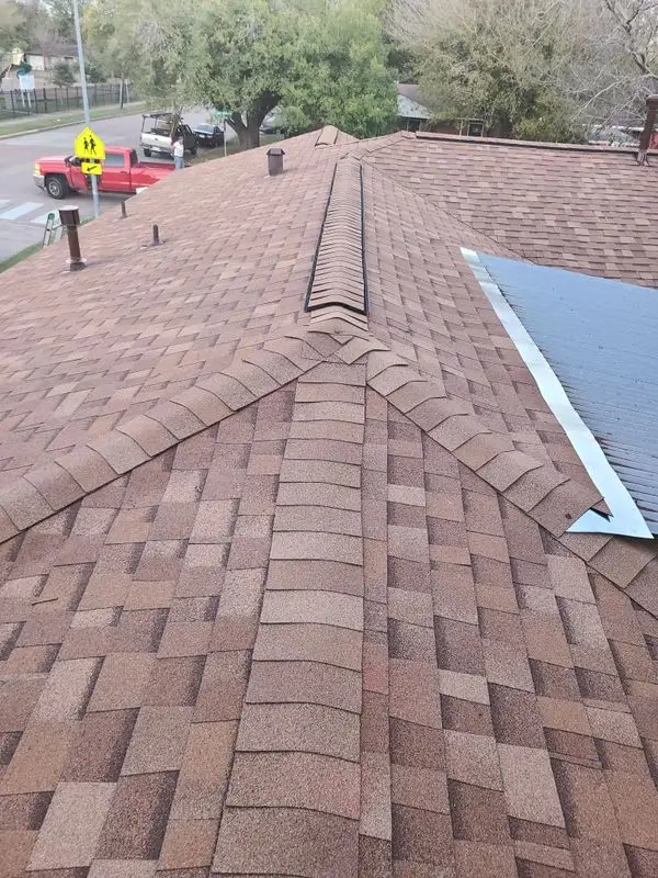 Brown architectural shingle roof with a ridge vent
