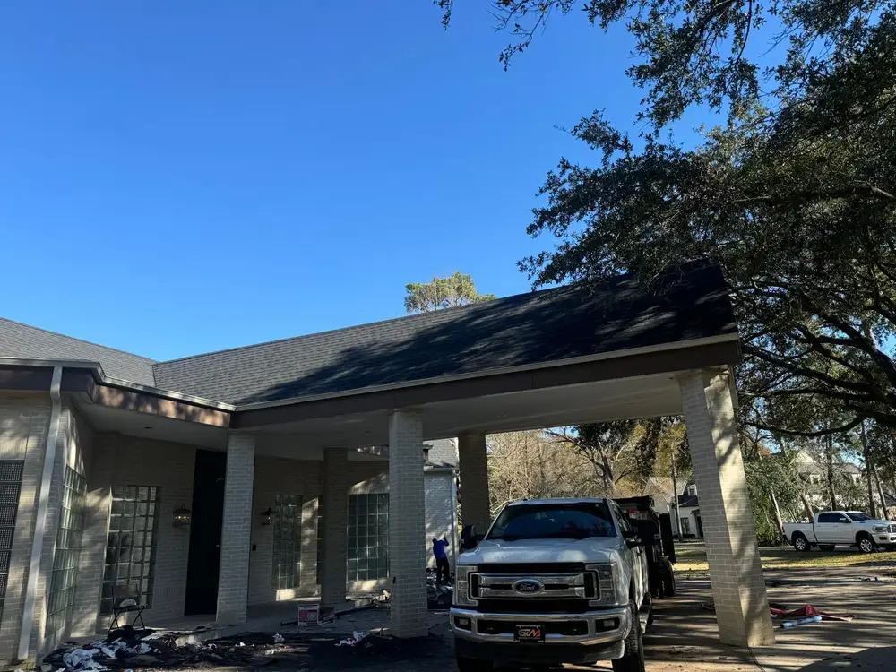 House with a new shingle roof over a covered drive